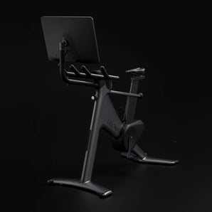 Indoor cycling bike console and grips with screen on a side mount