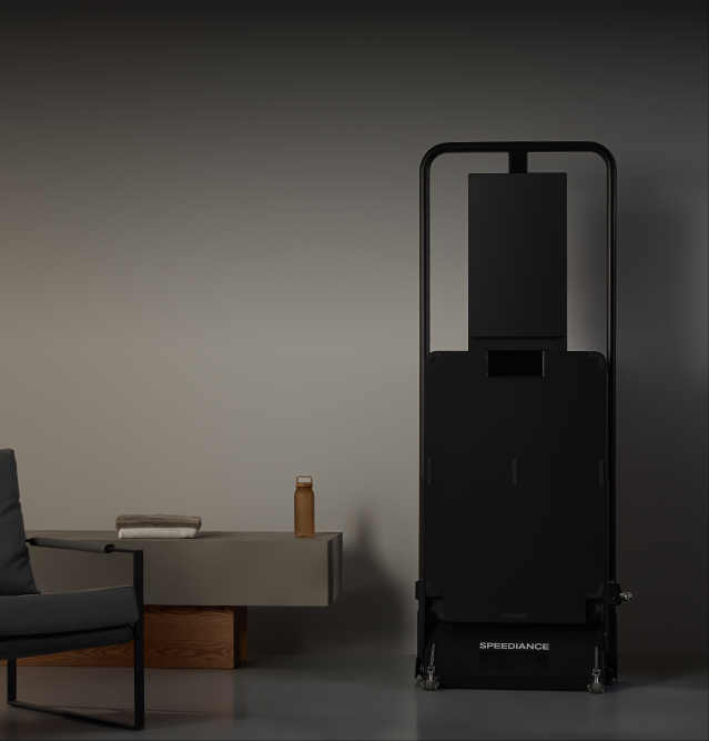 Gym Monster 3 folded flat beside a sideboard and an armchair