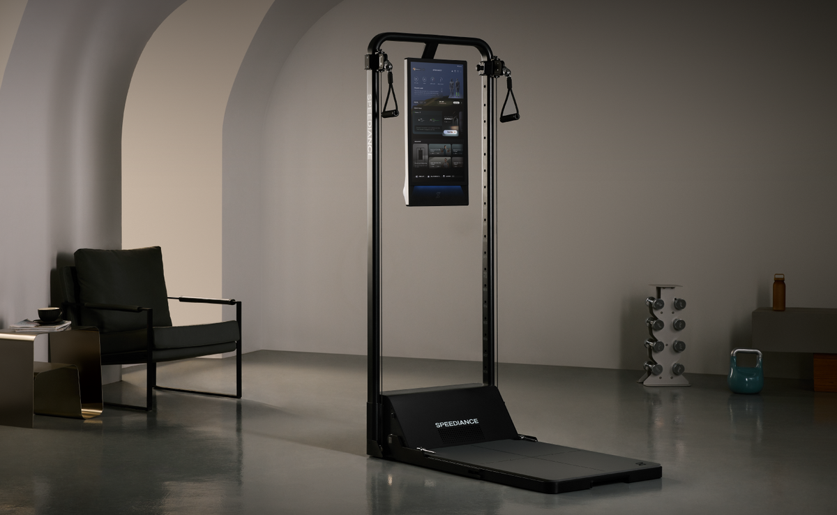 Gym Monster 3 standing in a calm living room beside an armchair