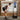 Workout machine with touchscreen; user leans forward holding resistance handles